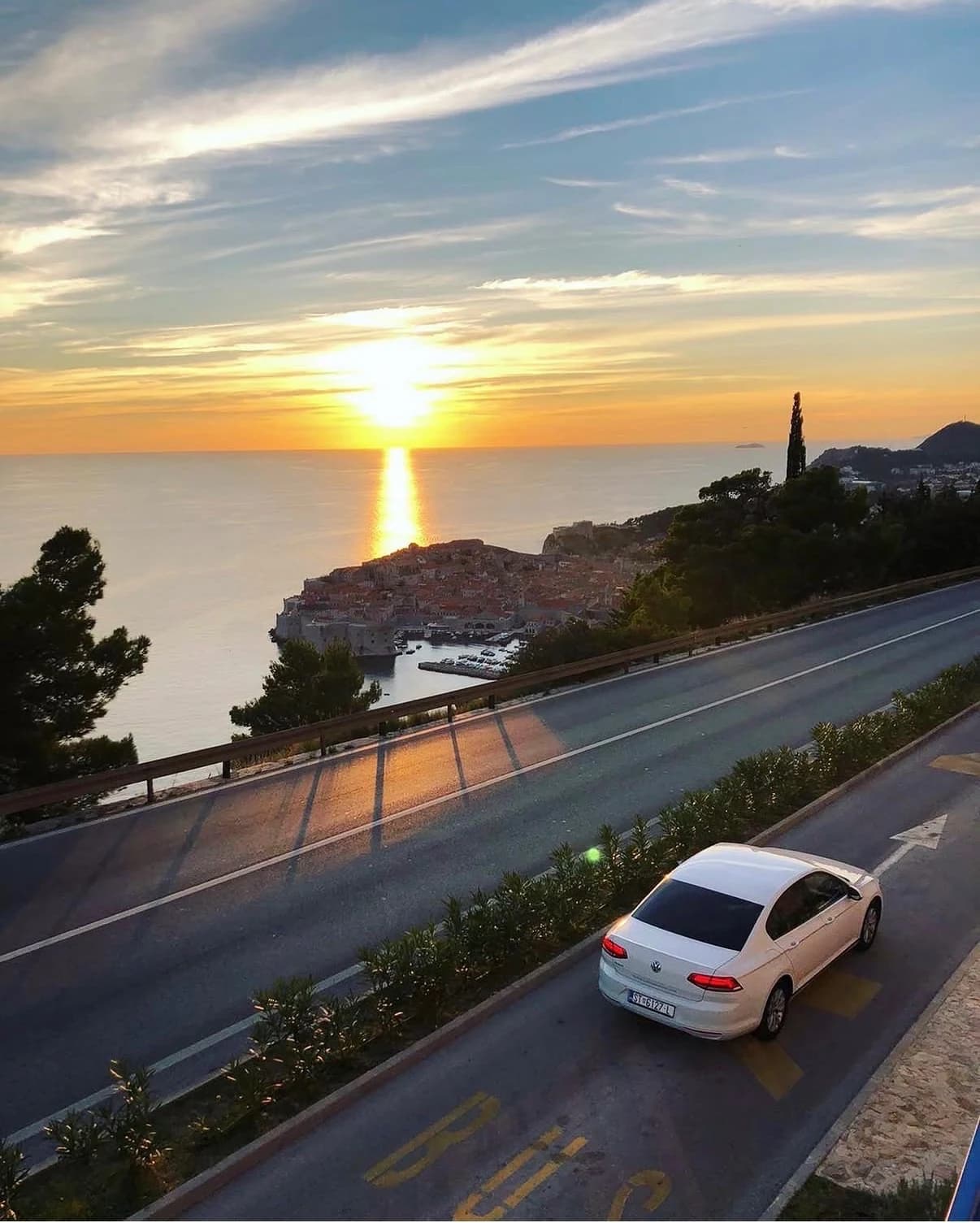 Car on the coastal route to Dubrovnik with a panoramic view of the Old Town, Croatia